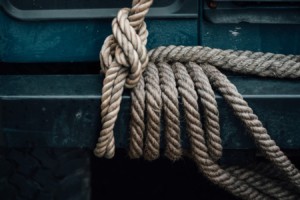 Rope tying skillfully around a steel rail