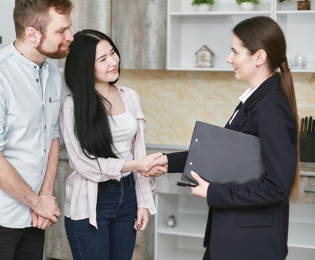 Lawyer shakes hands with a couple