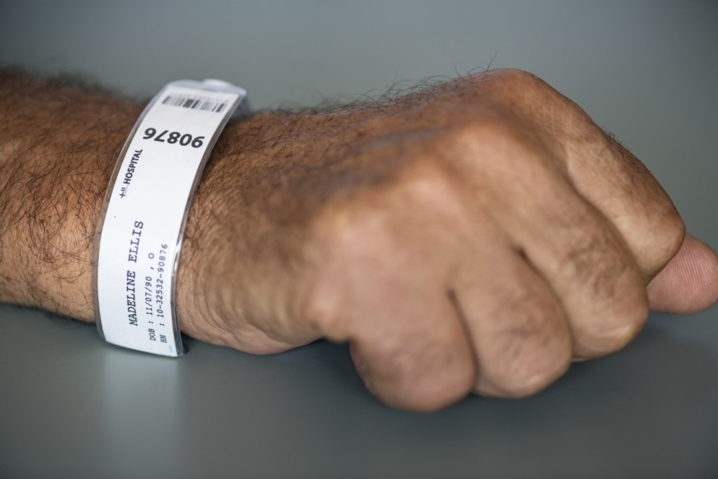 a patient's hospital wristband displays an upcoded diagnosis code